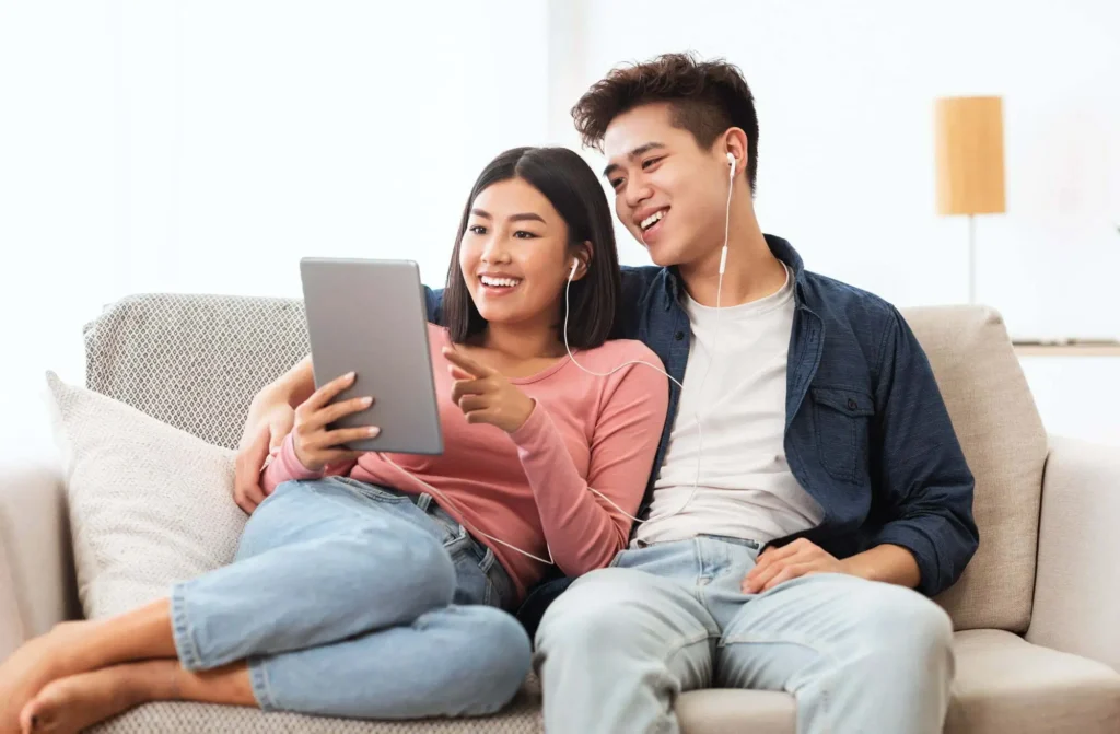 couple using digital tablet browsing internet at home